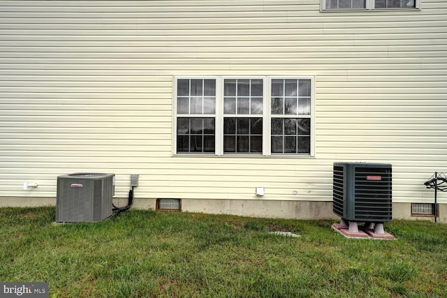 view of property exterior featuring a lawn and central air condition unit