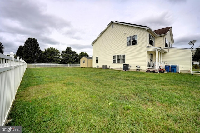 back of house featuring a shed and a yard