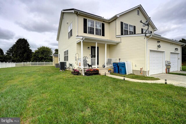 13 Kennison Ln, Dover, DE 19901 - view of front of house with central AC unit, a front yard, a porch, fence, and concrete driveway