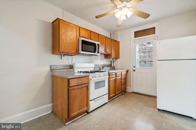 kitchen featuring ceiling fan, sink, and white appliances