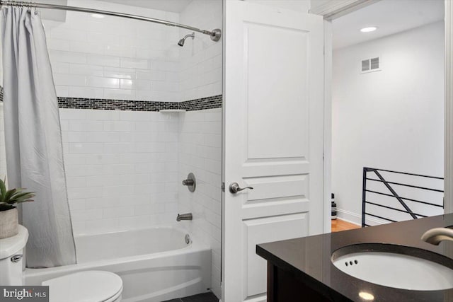 full bathroom featuring vanity, toilet, and shower / tub combo with curtain