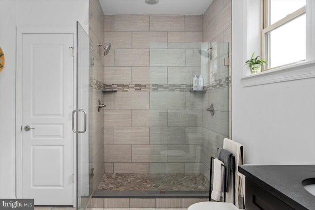 bathroom featuring vanity, toilet, and an enclosed shower