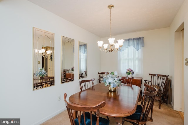 carpeted dining room with an inviting chandelier