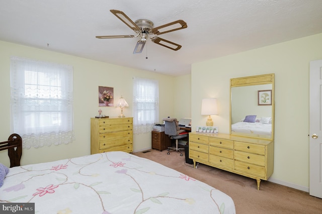 bedroom with ceiling fan and light colored carpet