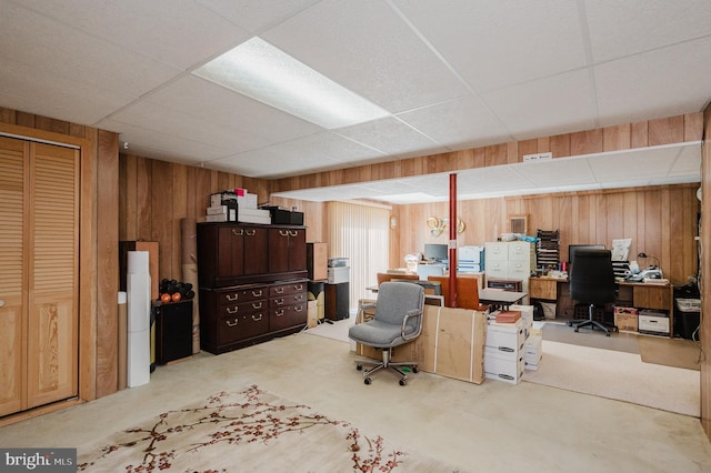 office with a drop ceiling and wooden walls