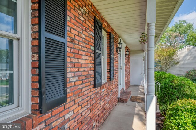 view of side of property with a porch