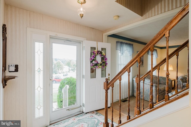 foyer entrance featuring a wealth of natural light and hardwood / wood-style flooring