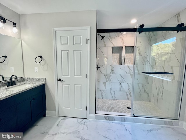 bathroom featuring vanity and a shower with shower door