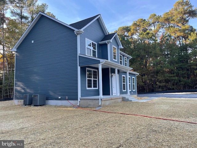 view of property exterior with a porch and cooling unit