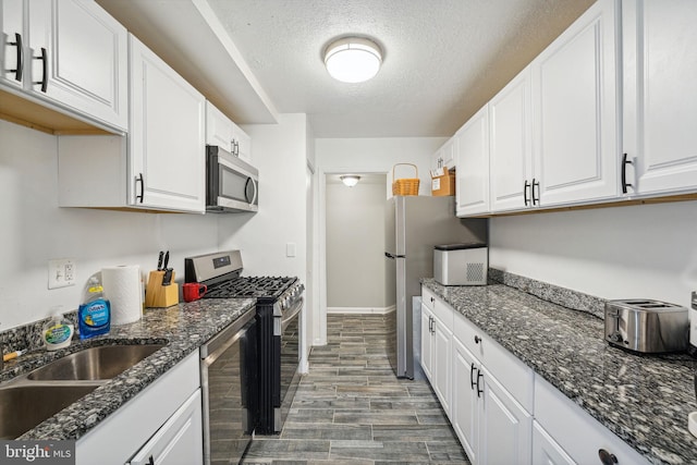 kitchen featuring stainless steel appliances, white cabinetry, and wood-type flooring