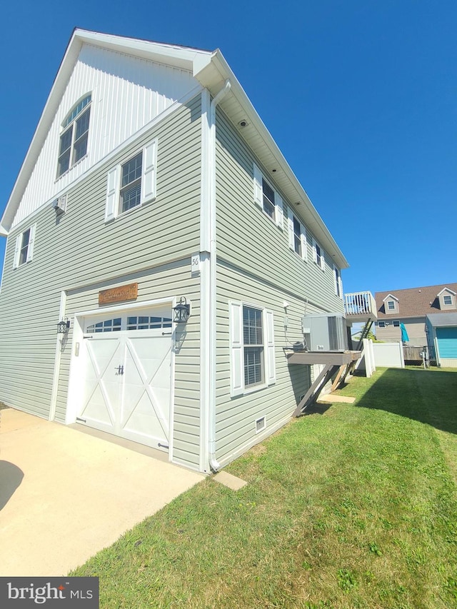 view of side of property featuring a garage, a deck, and a yard