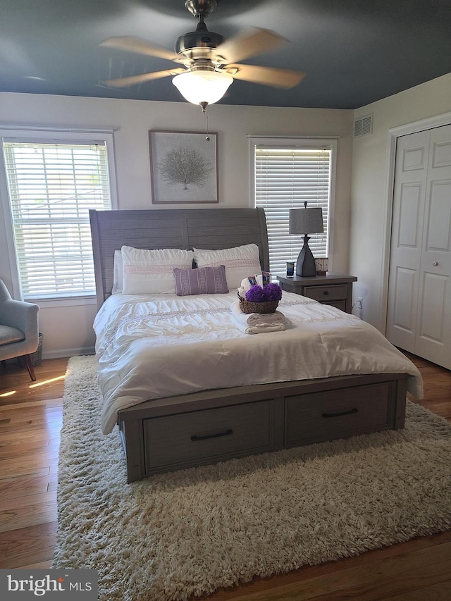 bedroom with a closet, ceiling fan, and hardwood / wood-style flooring