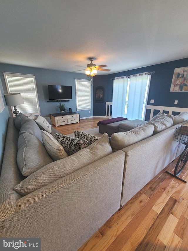 living room with ceiling fan, hardwood / wood-style flooring, and a healthy amount of sunlight