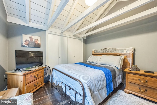 bedroom featuring lofted ceiling with beams and wooden ceiling