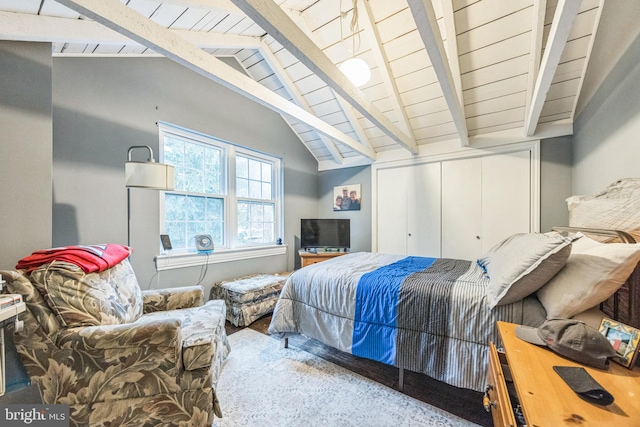 bedroom with wood ceiling, lofted ceiling with beams, and a closet