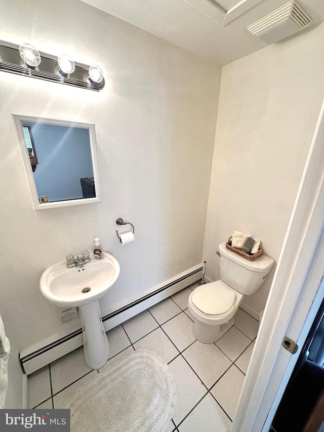 bathroom with toilet and tile patterned floors