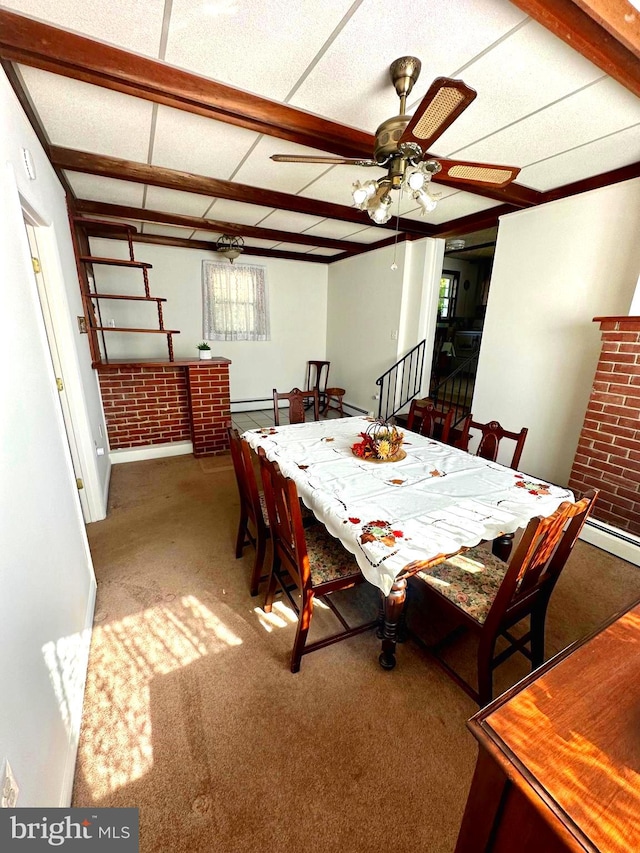 dining room featuring baseboard heating, carpet, and ceiling fan