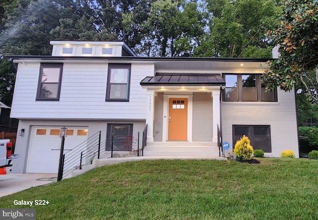 view of front of property with a front lawn and a garage