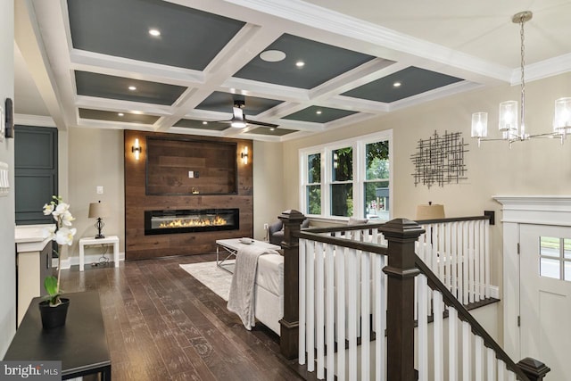 hall with beam ceiling, coffered ceiling, dark hardwood / wood-style flooring, and a wealth of natural light