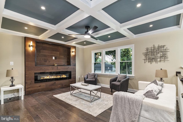 bedroom with coffered ceiling, dark hardwood / wood-style floors, beam ceiling, and a large fireplace