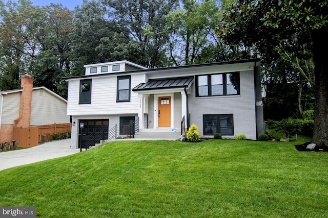 raised ranch with a garage and a front lawn