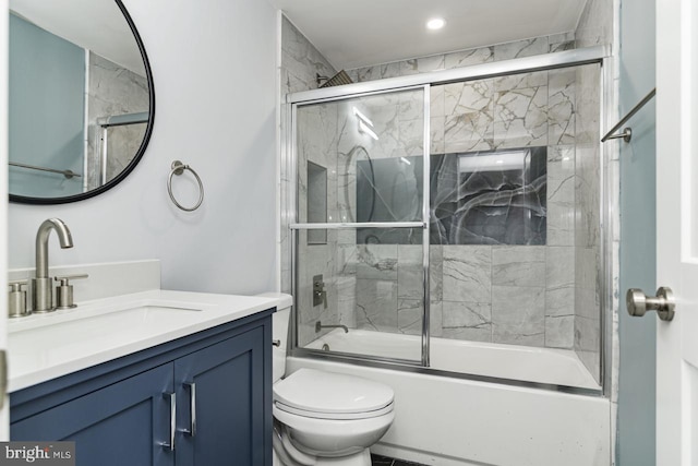 full bathroom with bath / shower combo with glass door, vanity, and toilet