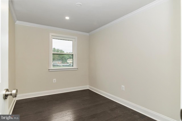 spare room with crown molding and dark hardwood / wood-style flooring