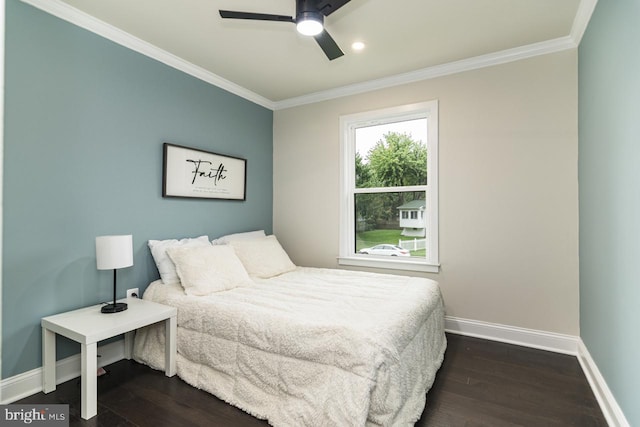 bedroom with crown molding, dark hardwood / wood-style floors, and ceiling fan