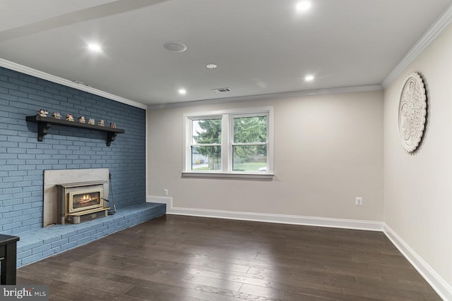 unfurnished living room with a wood stove, a brick fireplace, crown molding, and dark hardwood / wood-style flooring