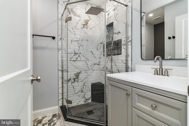 bathroom featuring vanity and an enclosed shower