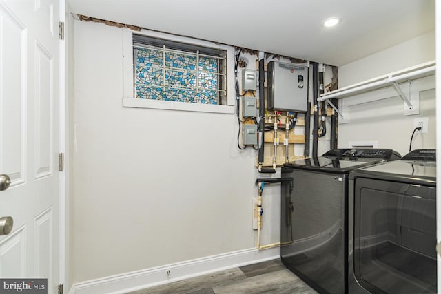 laundry room featuring dark hardwood / wood-style flooring and washing machine and clothes dryer