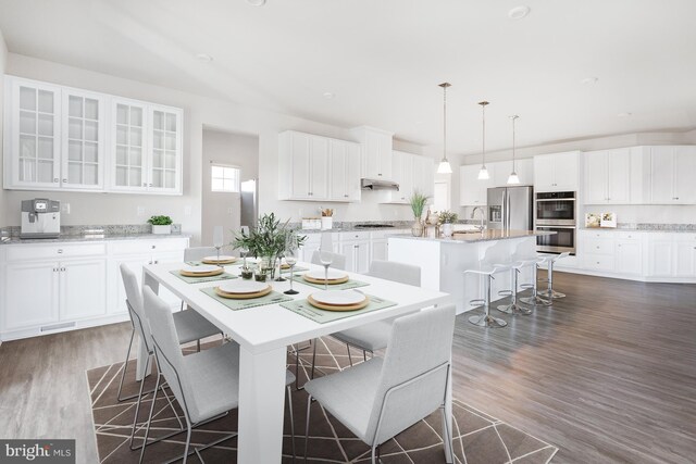 dining space featuring sink and dark hardwood / wood-style floors