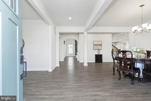 foyer featuring a chandelier, dark hardwood / wood-style floors, and beamed ceiling