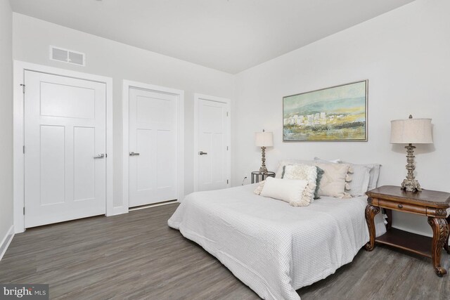 bedroom with dark wood-type flooring