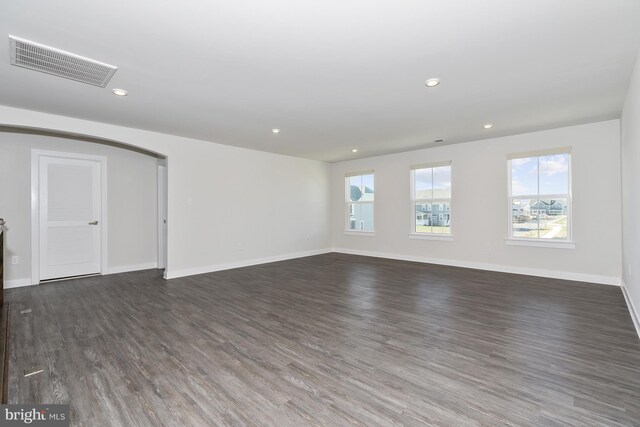 empty room with dark hardwood / wood-style flooring