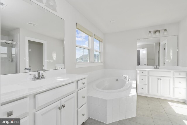 bathroom with tile patterned flooring, vanity, and shower with separate bathtub