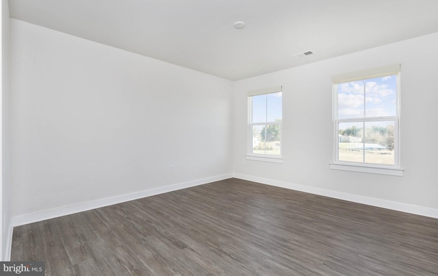 unfurnished room with dark hardwood / wood-style flooring