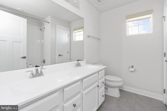 bathroom featuring tile patterned floors, vanity, and toilet