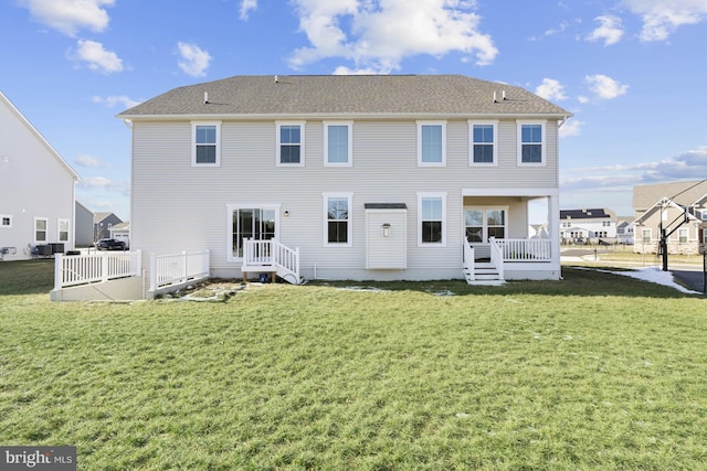 rear view of house with a yard