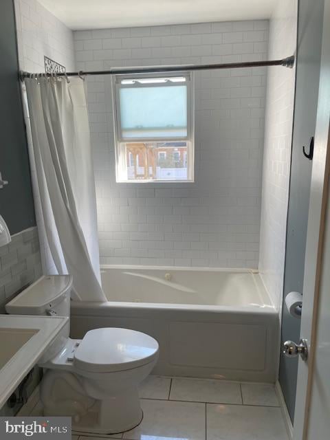 bathroom with tile patterned floors, toilet, and shower / tub combo