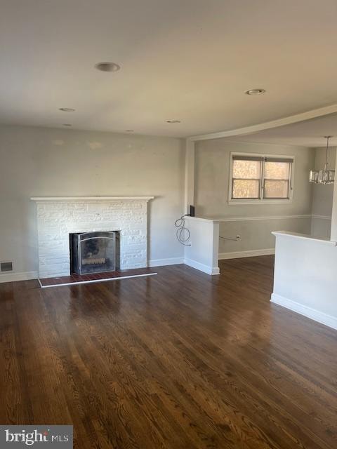 unfurnished living room with dark hardwood / wood-style flooring