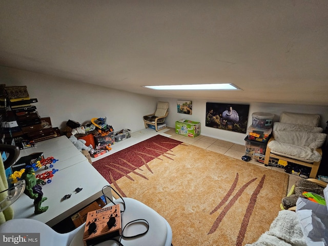 tiled living room featuring a skylight