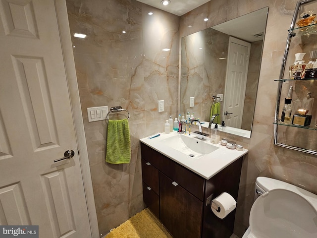 bathroom with vanity, tile walls, backsplash, and toilet