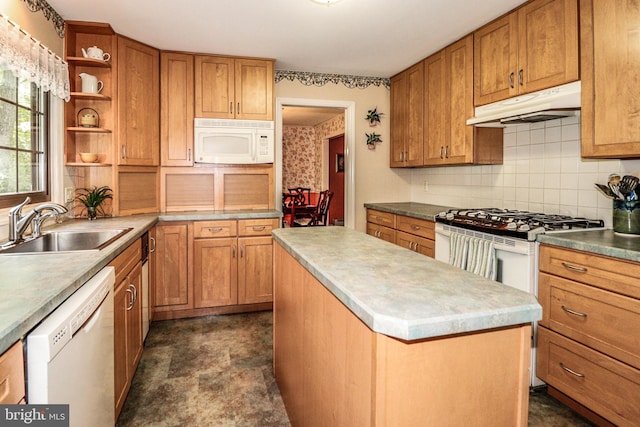 kitchen with a kitchen island, white appliances, and sink