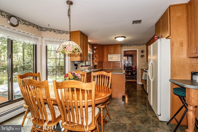 dining area with a baseboard radiator and sink