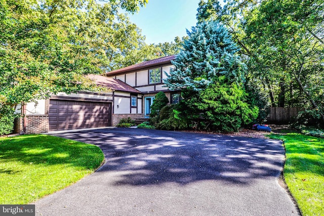 view of front of property featuring a garage and a front lawn