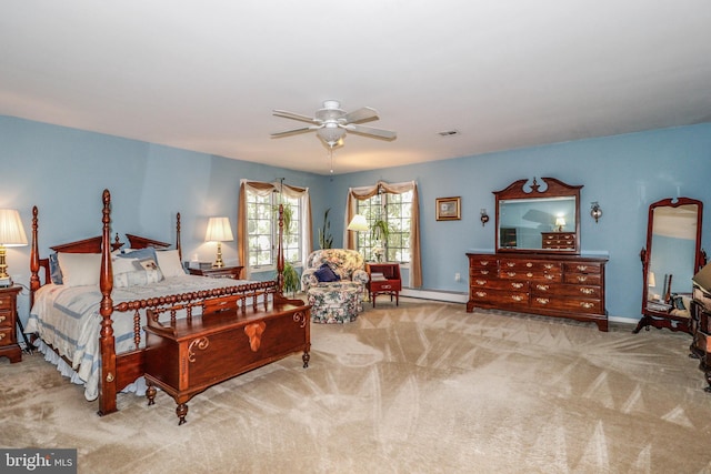 bedroom with baseboard heating, light carpet, and ceiling fan