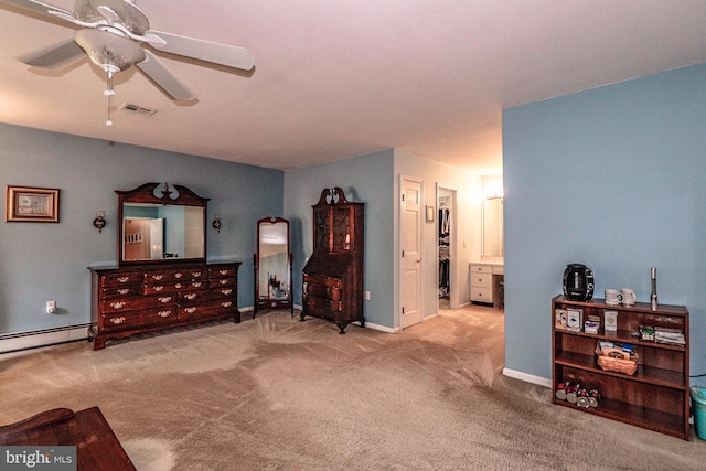 bedroom featuring baseboard heating, light carpet, ceiling fan, and ensuite bath