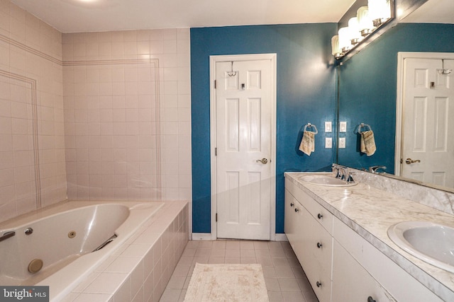 bathroom with vanity, tiled tub, and tile patterned floors