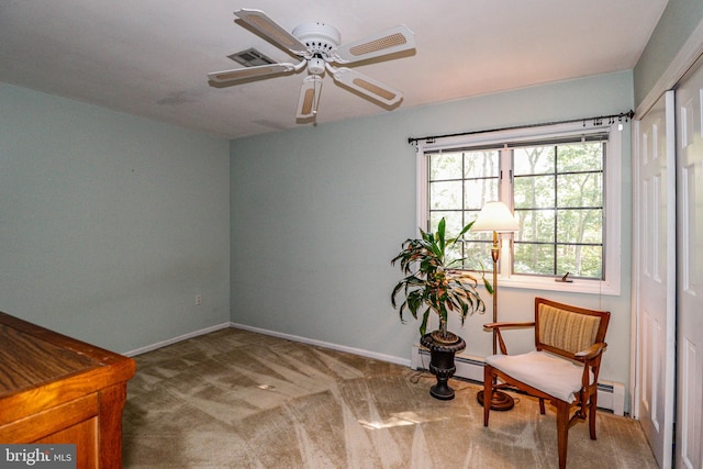 sitting room with ceiling fan and carpet flooring